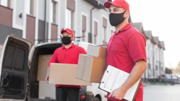 front-view-delivery-men-with-mask Furniture Movers and Packers in Dubai – Professional Moving Services